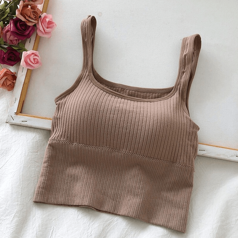 Fashionable cropped sports women's top with straps, ribbed design, displayed on a white background with roses.